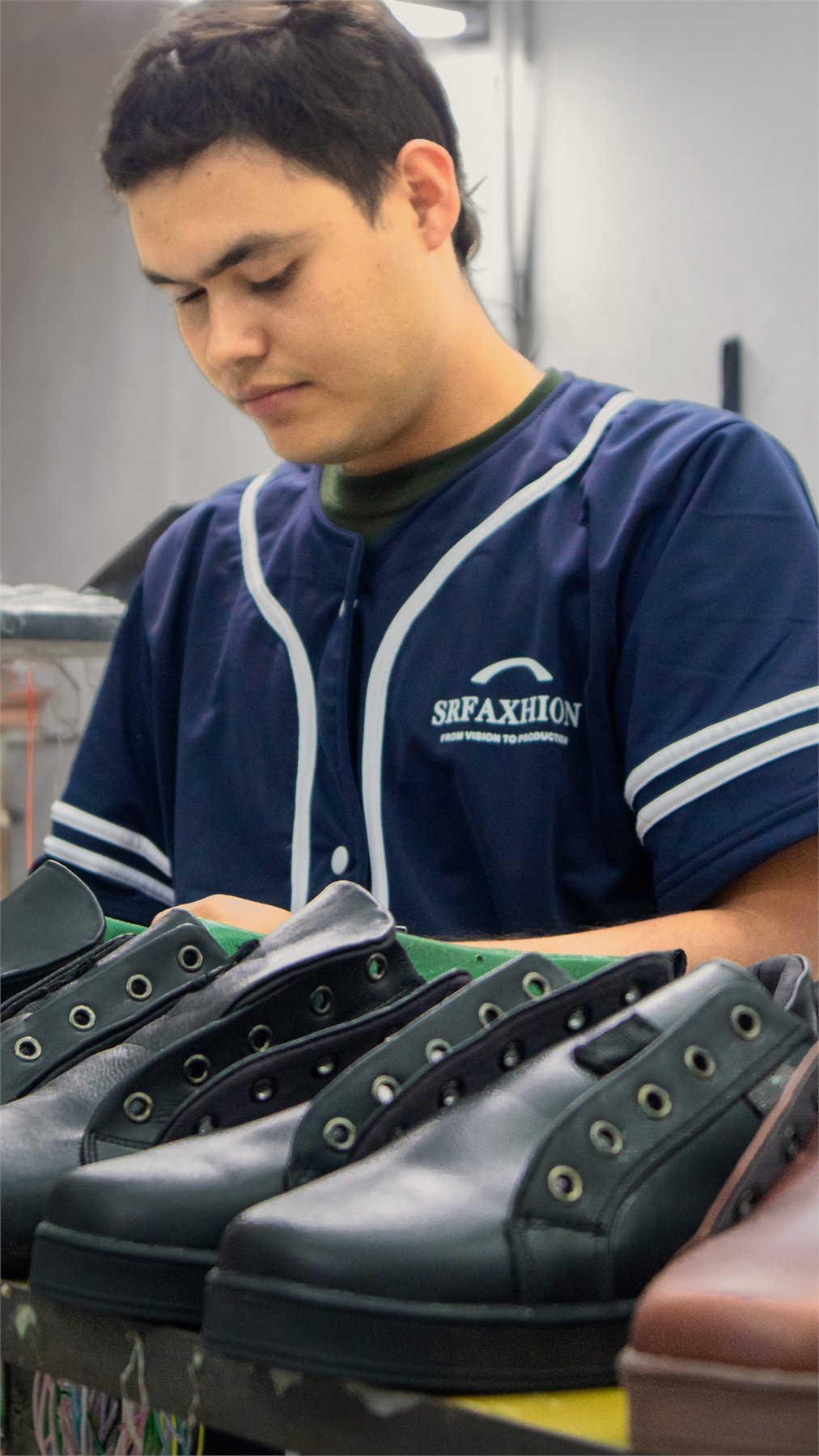 SR Faxhion craftsperson finishing a row of leather shoes